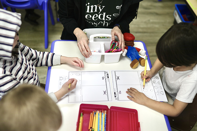 Working together Tiny Seeds students working at a table